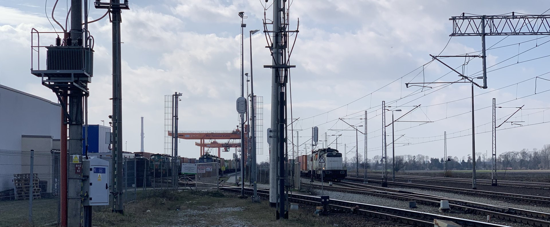 Freight train and container-handling equipment at a railway terminal